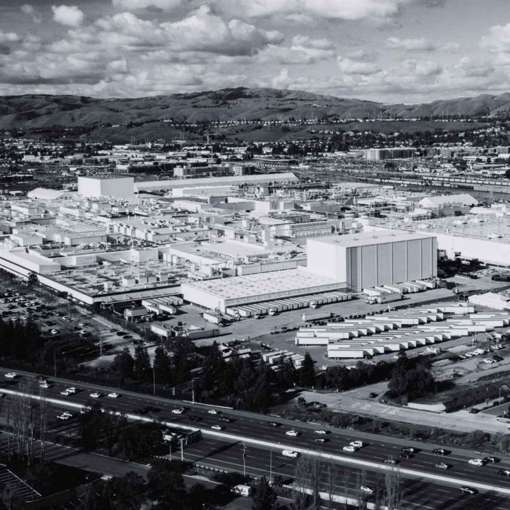 Large manufacturing facility with production buildings, equipment areas, and distribution infrastructure