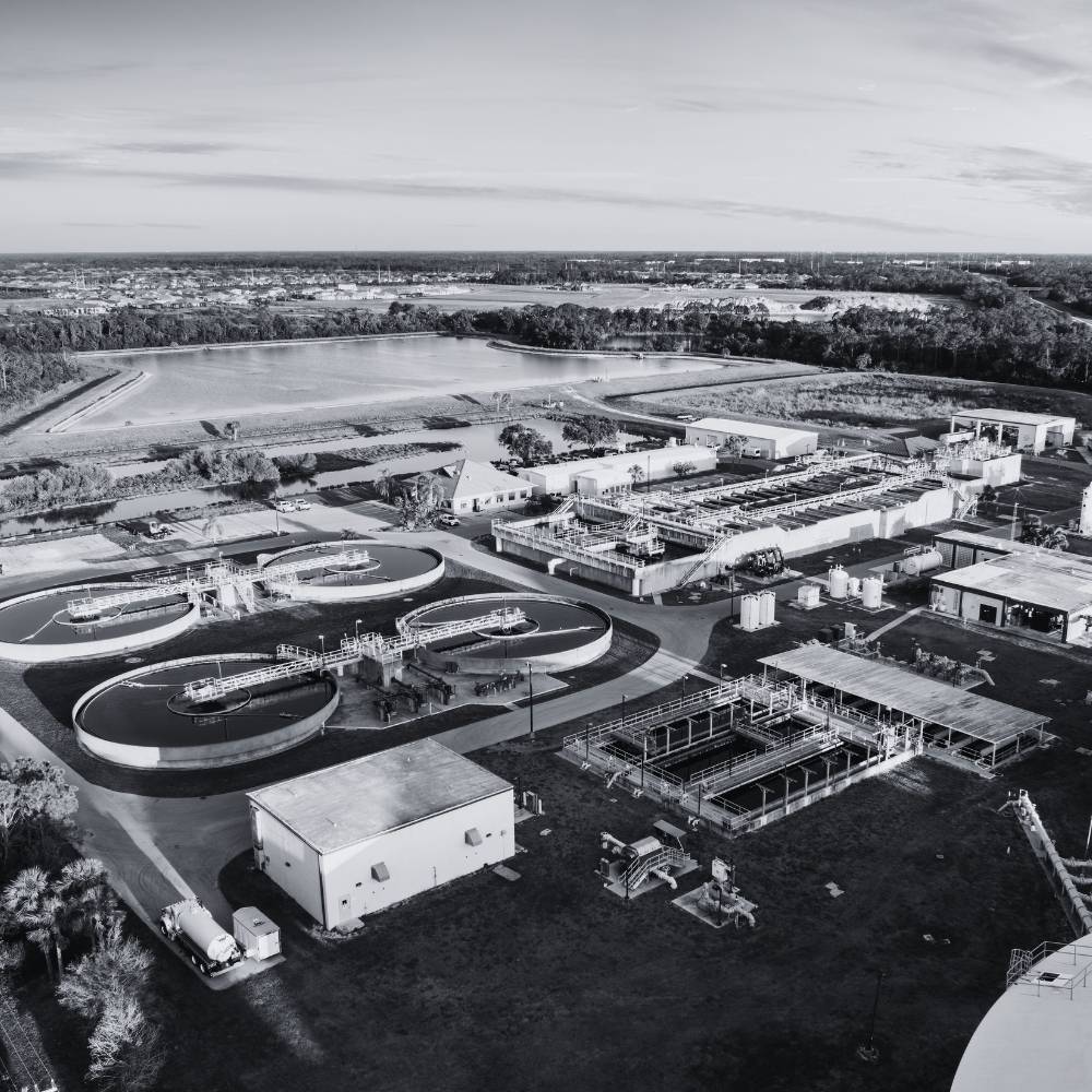 Aerial view of an industrial water treatment facility with tanks, process equipment, and supporting infrastructure