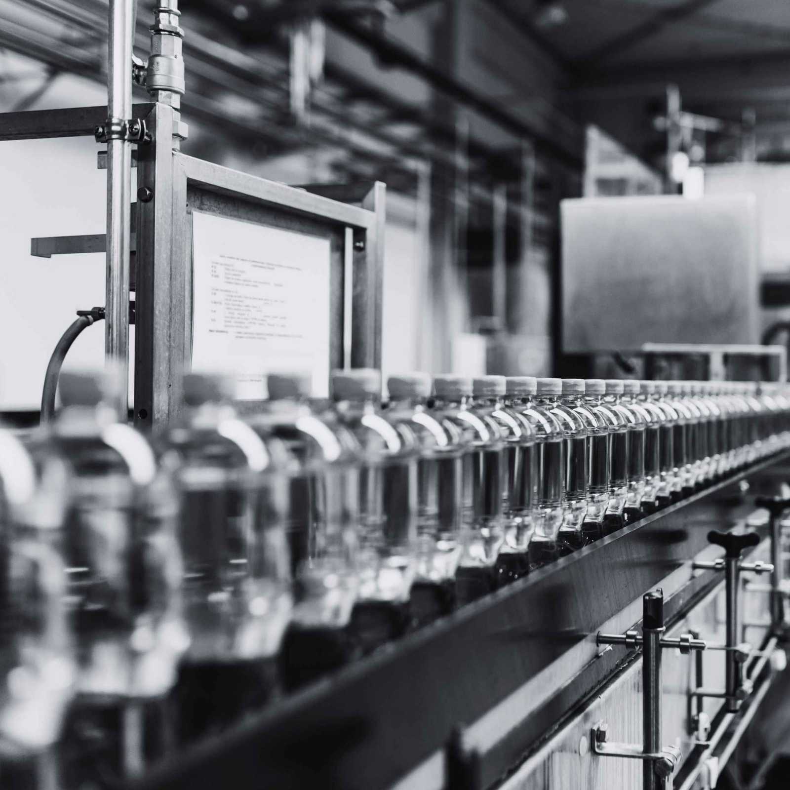 Industrial production line with products moving through automated manufacturing equipment