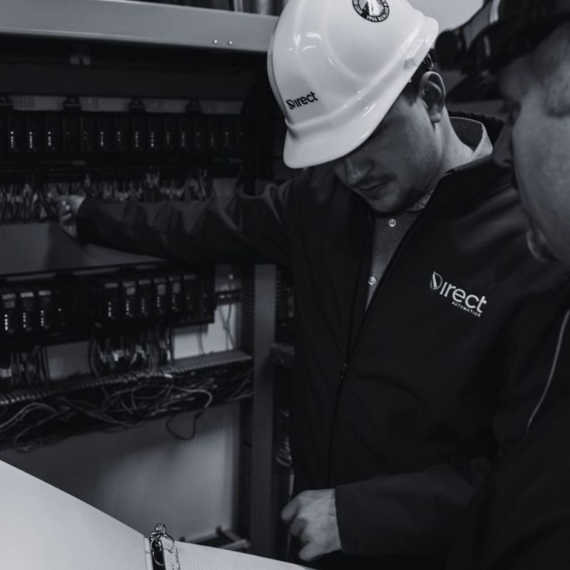 Direct Automation technician working inside a control panel at a critical facility
