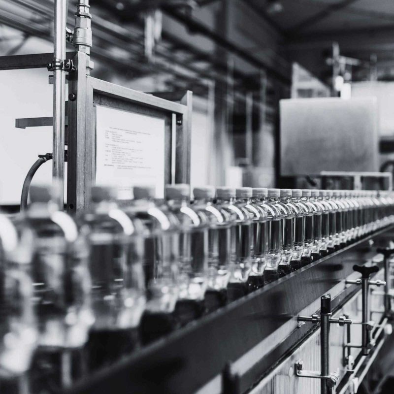 Bottled beverages moving through an automated production and packaging line