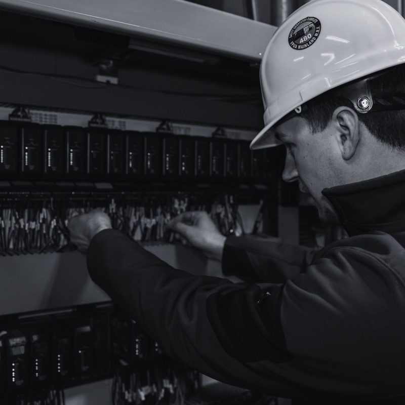 Direct Automation technician working on industrial control systems