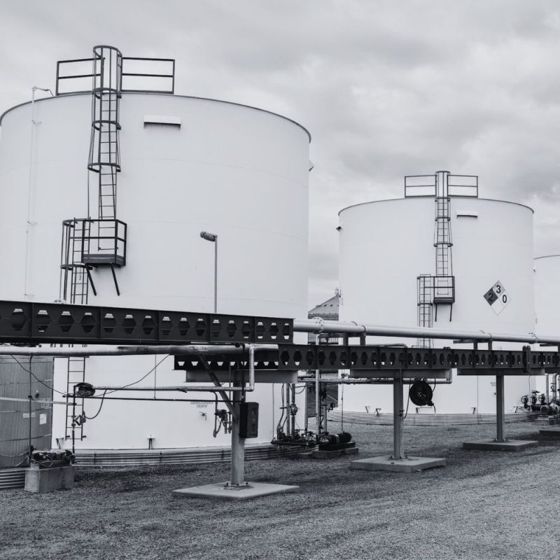 Industrial storage tanks and piping at an oil and gas facility