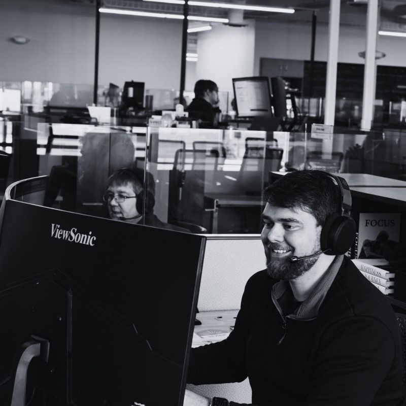 Direct IT support technician working at a computer in an office environment