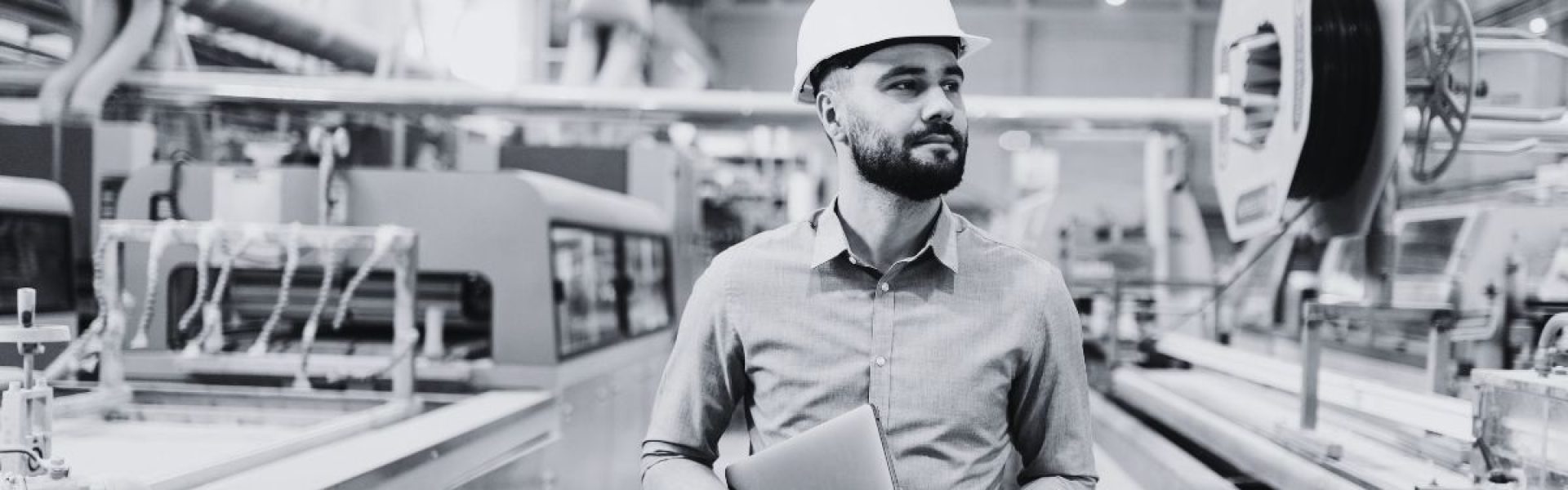Engineer reviewing panel fabrication process with clipboard showing how outsourcing improves supply chain resilience